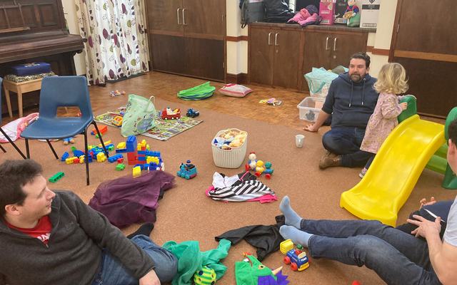 Dads and a toddler in the play space at Dads and Tots in Nutley Church hall