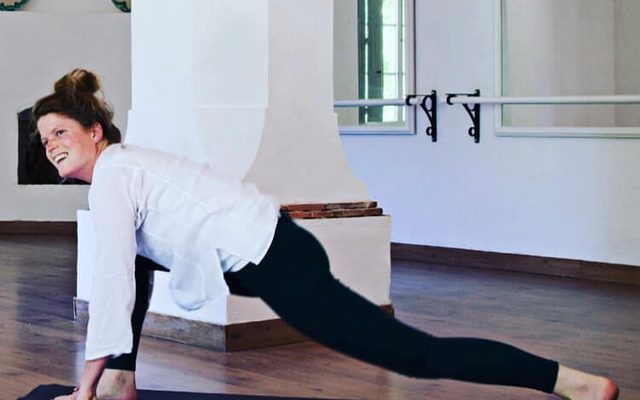 Yoga teacher in a stretch at Forest Row Village Hall