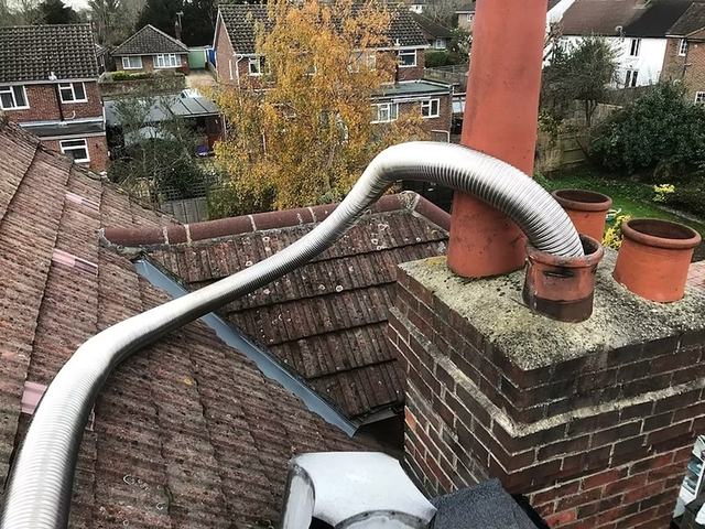 A chimney liner being installed